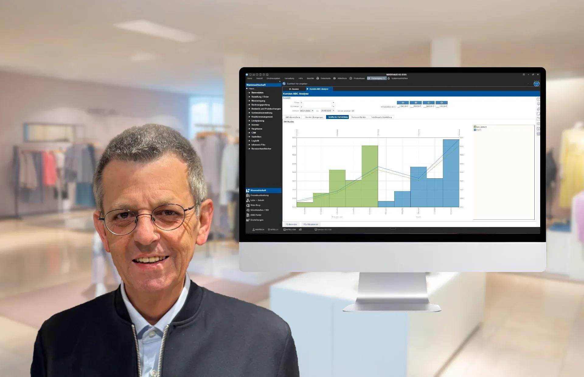 A smiling man with glasses in a retail store next to a monitor showing data analytics.